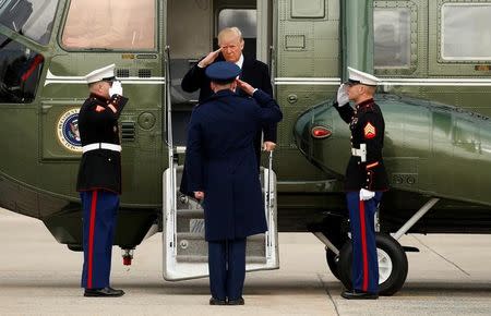 U.S. President Donald Trump salutes as he steps from Marine One to board Air Force One upon his departure from Joint Base Andrews in Maryland, U.S., February 17, 2017. REUTERS/Kevin Lamarque