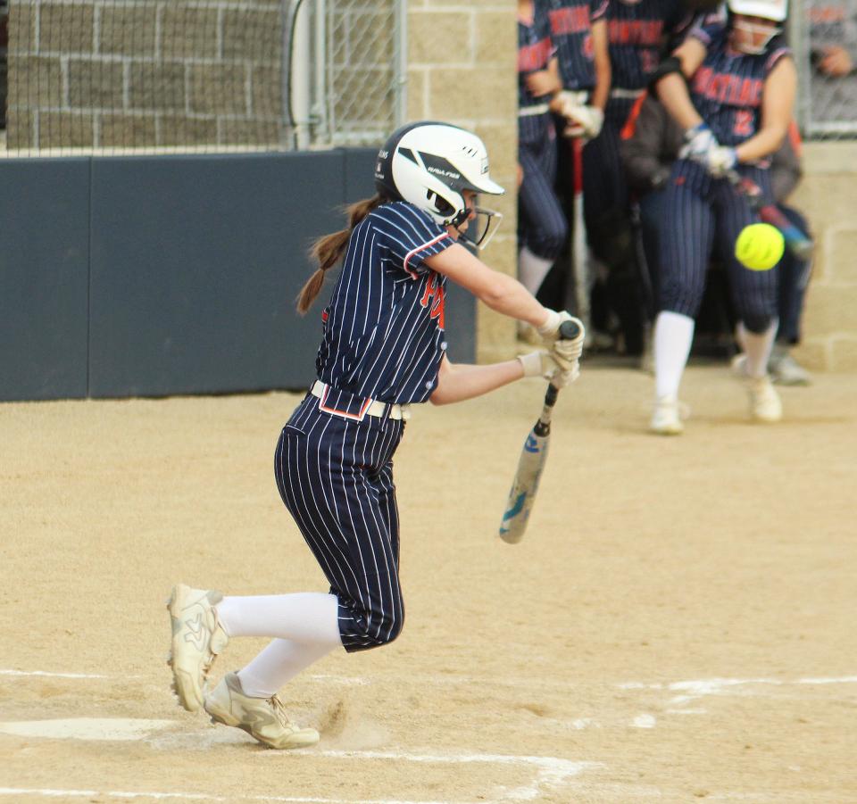 Tessa Collins of Pontiac slaps at the ball Monday. Collins singled on this play to help key an eight-run outburst that led to a 12-2 victory over Monticello.