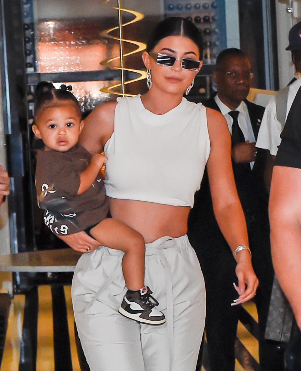 Kylie Jenner carries baby Stormi