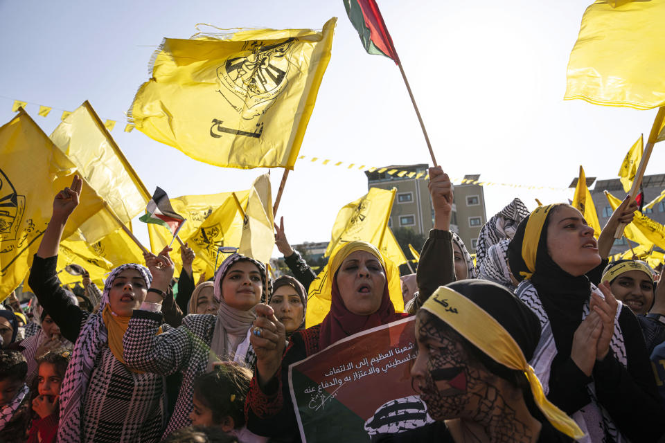 Palestinians chant slogans and wave yellow Fatah movement flags during a rally marking the 18th anniversary of the death of Fatah founder and Palestinian Authority leader Yasser Arafat in Gaza City, Thursday, Nov. 10, 2022. (AP Photo/Fatima Shbair)