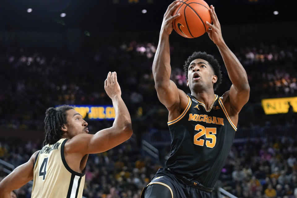 Michigan guard Jace Howard (25) drives on Purdue forward Trey Kaufman-Renn (4) in the second half of an NCAA college basketball game in Ann Arbor, Mich., Thursday, Jan. 26, 2023. (AP Photo/Paul Sancya)