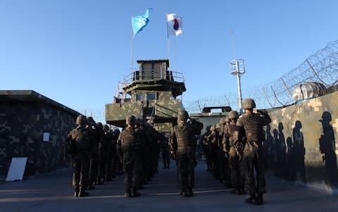 South Korean soldiers leave a border guard post at an undisclosed area in the Demilitarized Zone (DMZ) dividing the South and North Koreas - Credit: Getty