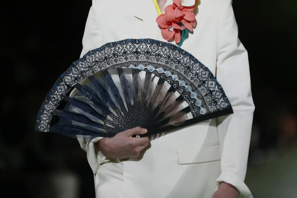 A model walks the runway wearing the Christian Dior pre-fall 2020 men's fashion collection during Art Basel on Tuesday, Dec. 3, 2019, in Miami. (AP Photo/Brynn Anderson)