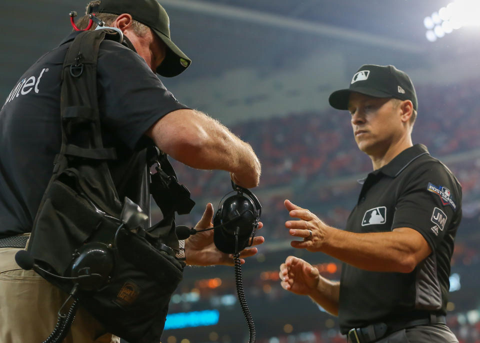 HOUSTON, TX - OCTOBER 04:  Umpire Mark Wegner (14) reviews a play during the ALDS Game 1 between the Tampa Bay Rays and Houston Astros on October 4, 2019 at Minute Maid Park in Houston, Texas.  (Photo by Leslie Plaza Johnson/Icon Sportswire via Getty Images)