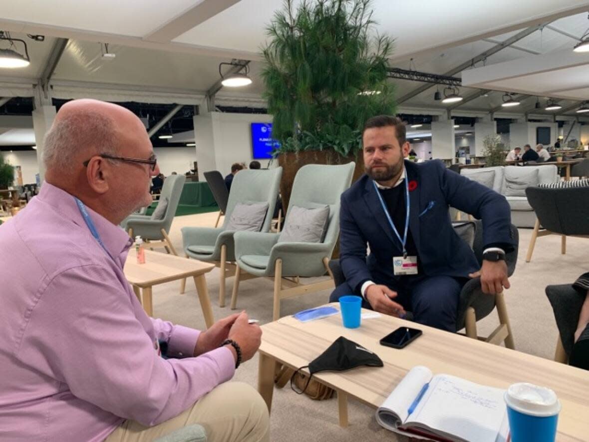 Shane Thompson, left, the N.W.T.'s minister of environment and natural resources, is at COP26, the UN climate change conference, telling people about the impacts of climate change on the territory.  (Shane Thompson/Twitter - image credit)