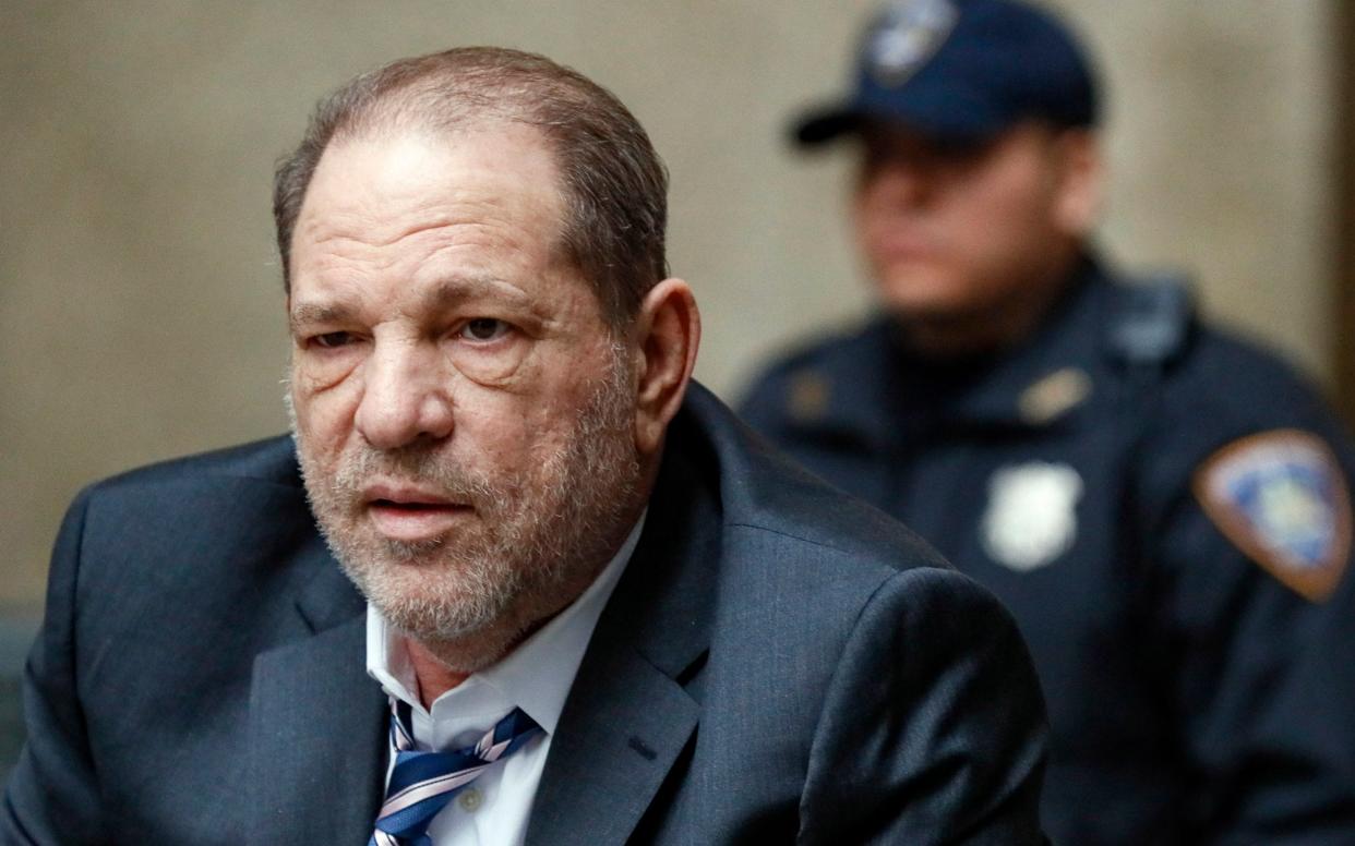 Harvey Weinstein departs a Manhattan courthouse during his rape trial in New York - John Minchillo /AP