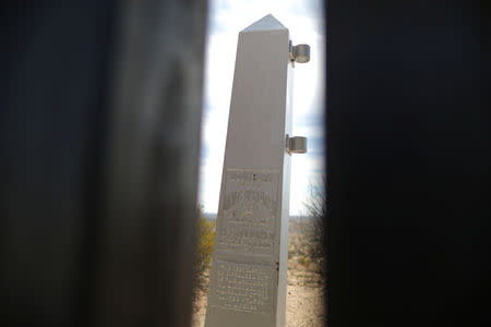 A U.S.-Mexico boundary marker is seen through new bollard-style U.S.-Mexico border fencing in Santa Teresa, New Mexico, U.S., March 5, 2019. REUTERS/Lucy Nicholson