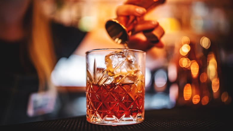 Bartender crafting a Negroni