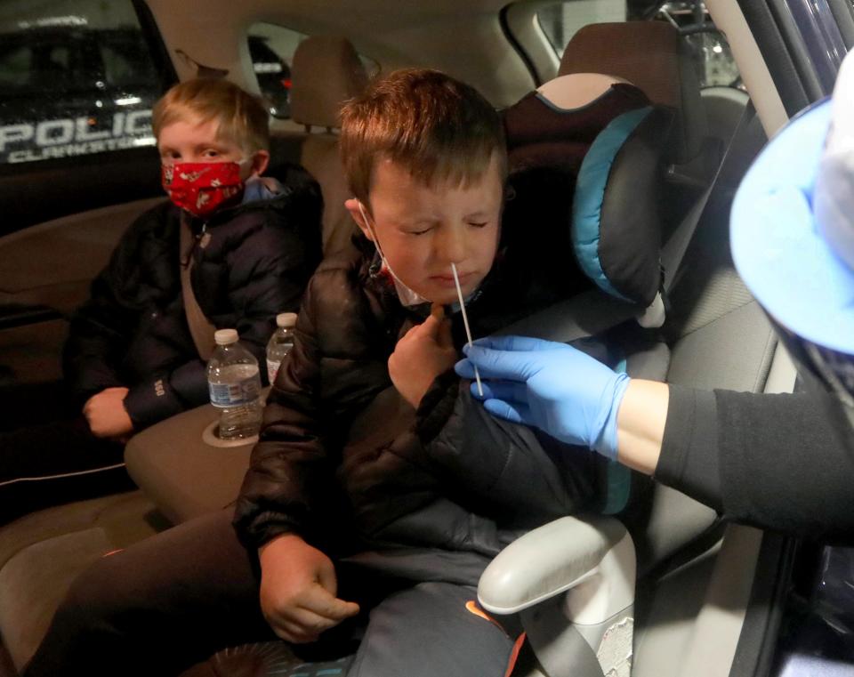 This 2020 file photo shows Sam Donohaue, then a kindergarten student at the R.P. Connor Elementary School in Suffern, getting a COVID-19 test at a testing site in the parking garage at the Palisades Center Mall on Nov. 30, 2020.