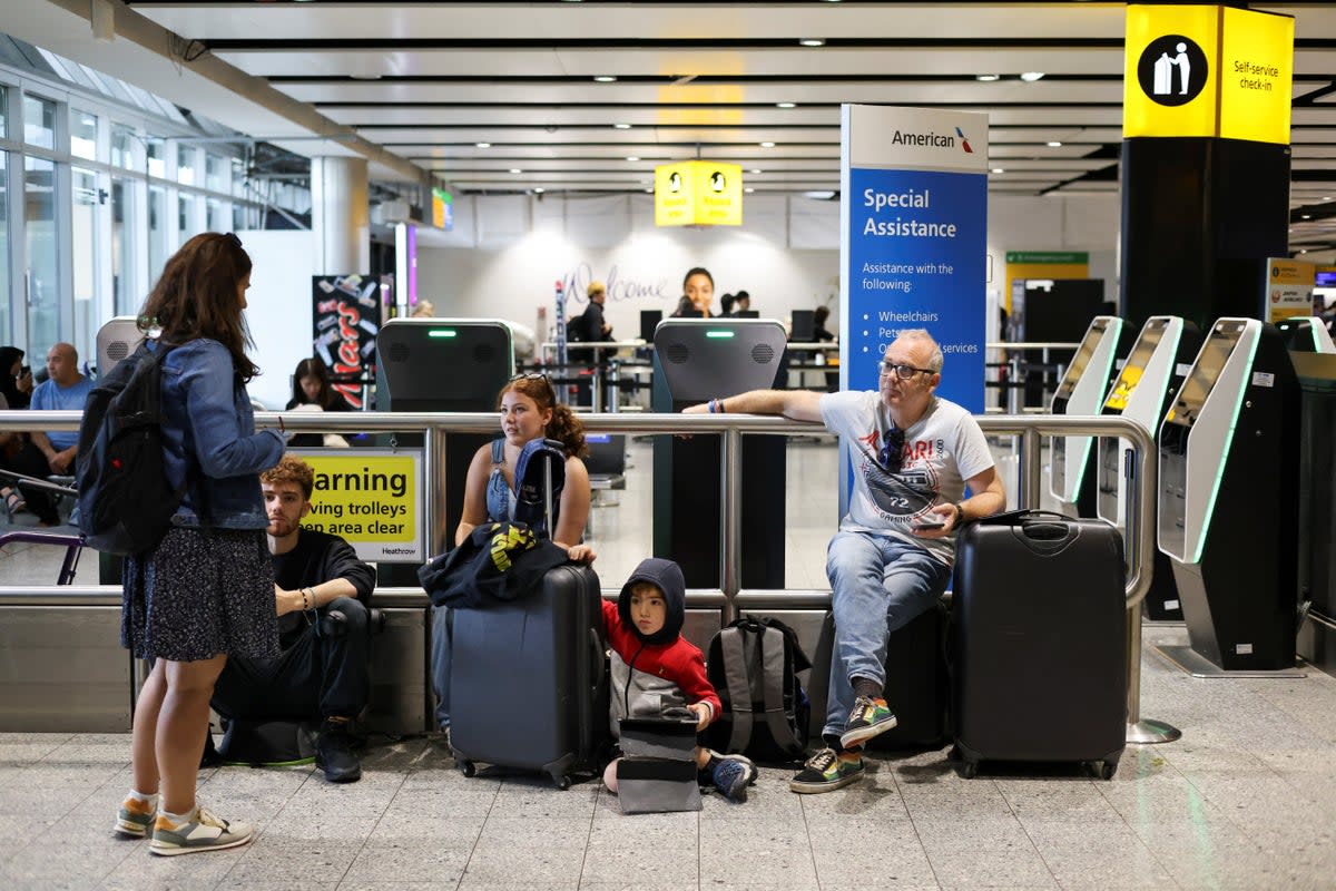 A family waits for flight information after the  National Air Traffic Service (NATS) restricted air traffic (REUTERS)