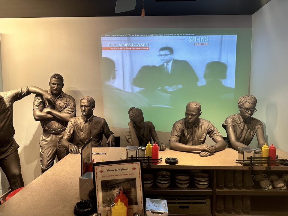 An exhibit depicting the lunch counter sit-ins during 1960 with students sitting at the counter while hecklers stand nearby at the National Civil Rights Museum in Memphis. (Vincent Goodwill/Yahoo Sports)