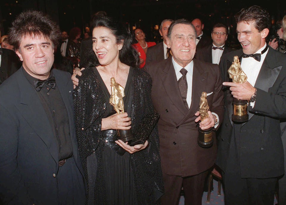 FILE - From left to right, Spanish director Pedro Almodovar, Greek actress Irene Papas, Italian actor Alberto Sordi and American actor Antonio Banderas pose with their International cinema awards "Rodlfo Valentino" during a gala evening in Berlin on Wednesday, Oct. 9, 1996. Greek actress and recording artist Irene Papas who stared along side Hollywood greats acting alongside Hollywood stars Gregory Peck, Anthony Quinn and Kirk Douglas, died Wednesday, Sept. 14, 2022, at the age of 93. (AP Photo/Jan Bauer, File)