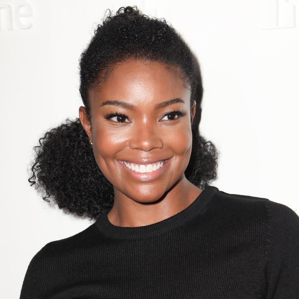 Gabrielle Union wore her natural curls in a high ponytail wrapped with gold wire to a NYFW party. Find out why we love her look here.
