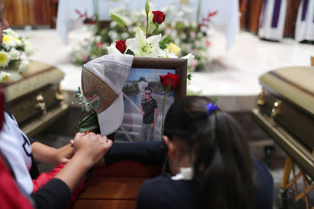 Relatives of a man who died in an explosion of a fuel pipeline ruptured by oil thieves react during a funeral mass at a church in the municipality of Tlahuelilpan, state of Hidalgo, Mexico January 21, 2019. REUTERS/Mohammed Salem