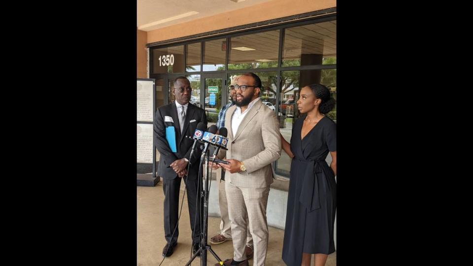 Jeffrey Obumseli, whose brother was killed by his girlfriend in a Miami condo, talks to reporters outside the State Attorney’s Office on April 8, 2022. To his left is lawyer Larry Handfield and cousin Sam Ndiw; to his right, another cousin, Karen Egvunna.