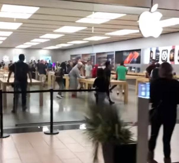 Customers stood by and watched as a group of young men pulled an Apple store theft in broad daylight - sprinting away with a computer and other devices. (Twitter/Gooneryoda)