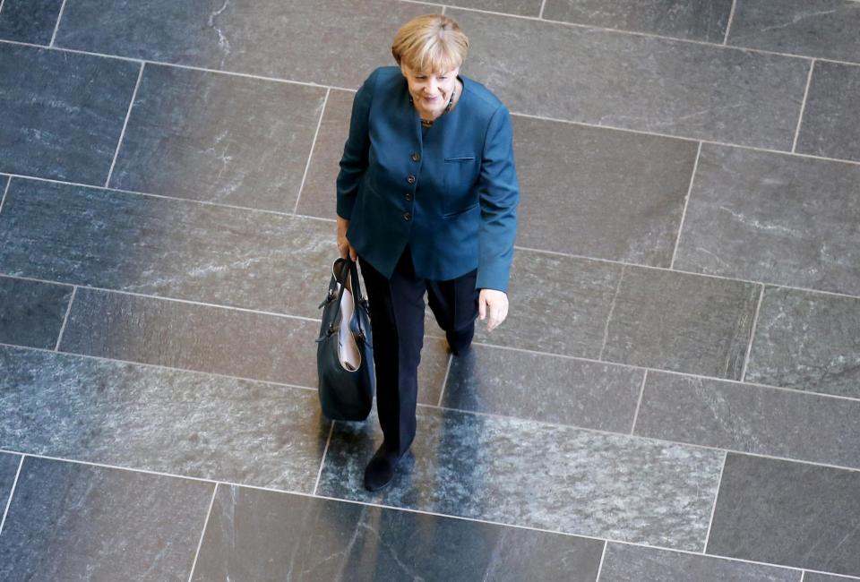 German Chancellor and leader of the Christian Democratic Union (CDU) Angela Merkel arrives for a meeting of senior party leaders before preliminary talks between Germany's conservative (CDU/CSU) parties and the Social Democrats (SPD) in Berlin October 4, 2013. The SPD are seen as the conservative chancellor's most likely partner, but they have said they will not be rushed into a deal. Merkel will also hold preliminary talks with the Greens next week, playing potential partners off against each other. REUTERS/Fabrizio Bensch (GERMANY - Tags: POLITICS TPX IMAGES OF THE DAY)