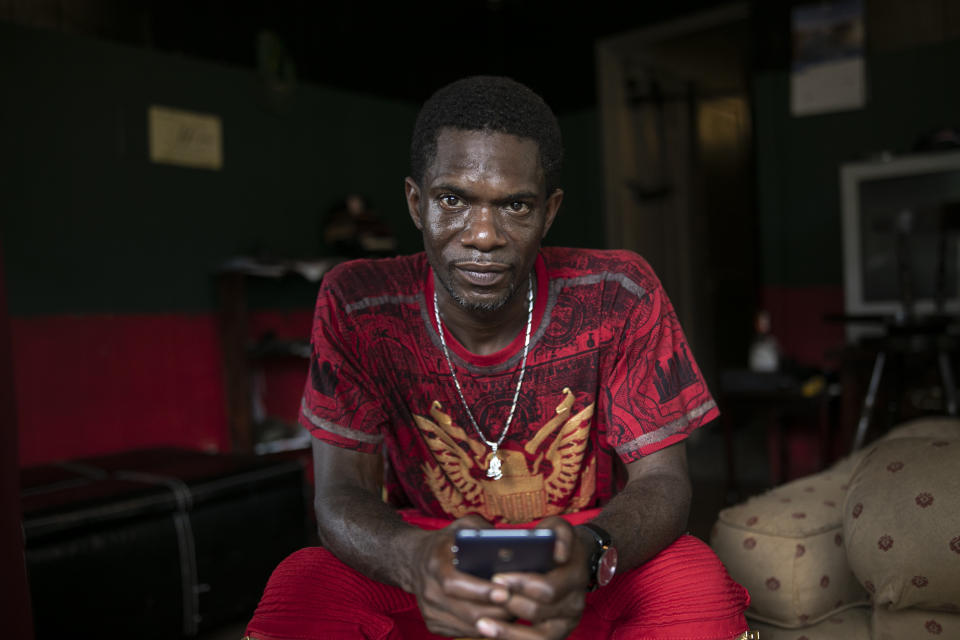 Joshua K. Love sits in the living room of his home in Greenwood, Miss., Saturday, June 8, 2019. Love says he was sexually abused by two Franciscan friars at a local Catholic grade school. (AP Photo/Wong Maye-E)