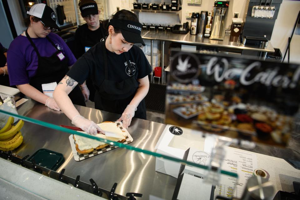 A trainer instructs new employees how to make a cinnacake at Cinnaholic, a vegan cinnamon roll bakery, at 1928 Skibo Road.