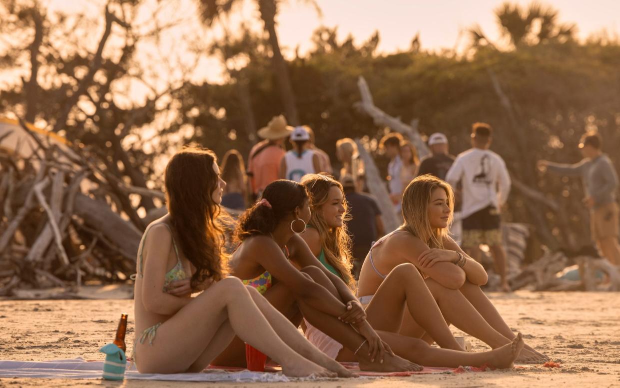 girls sat on beach - Jackson Lee Davis/Netflix 