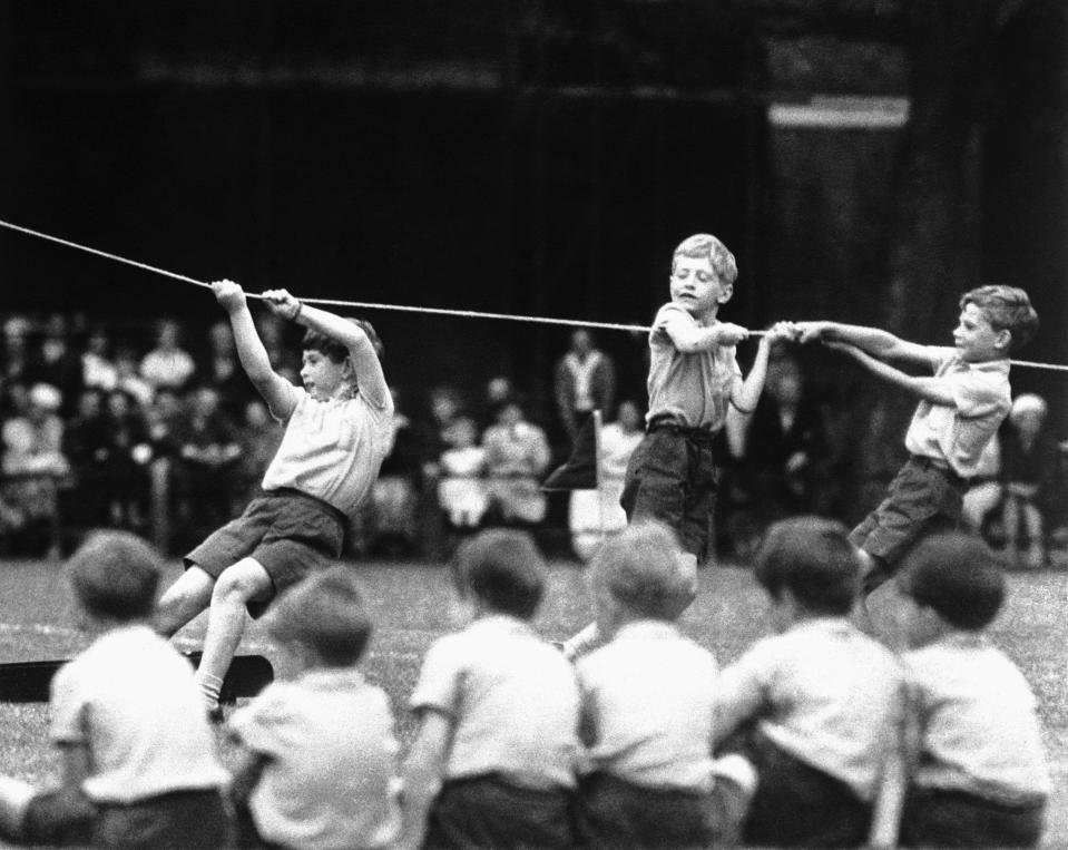 FILE - Britain's Prince Charles, center left, takes part in a sports day at Hill House School, in London, July 8, 1957. King Charles III hasn’t even been crowned yet, but his name is already etched on the walls of Hill House School in London. A wooden slab just inside the front door records Nov. 7, 1956, as the day the future king enrolled at Hill House alongside other notable dates in the school’s 72-year history. (AP Photo, File)