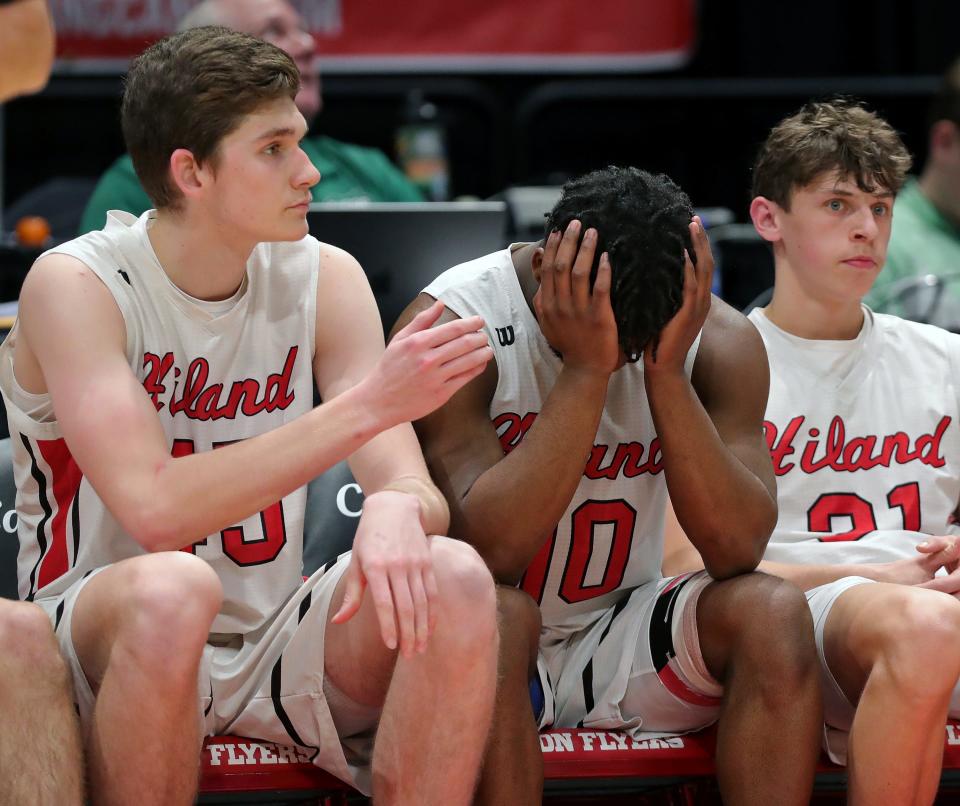 Hiland guard Phin Killy, center, is comforted by teammate Alex Yoder, left, as Crestview is up in the final moments of a Division IV state semifinal basketball game at UD Arena, Friday, March 17, 2023, in Dayton, Ohio.