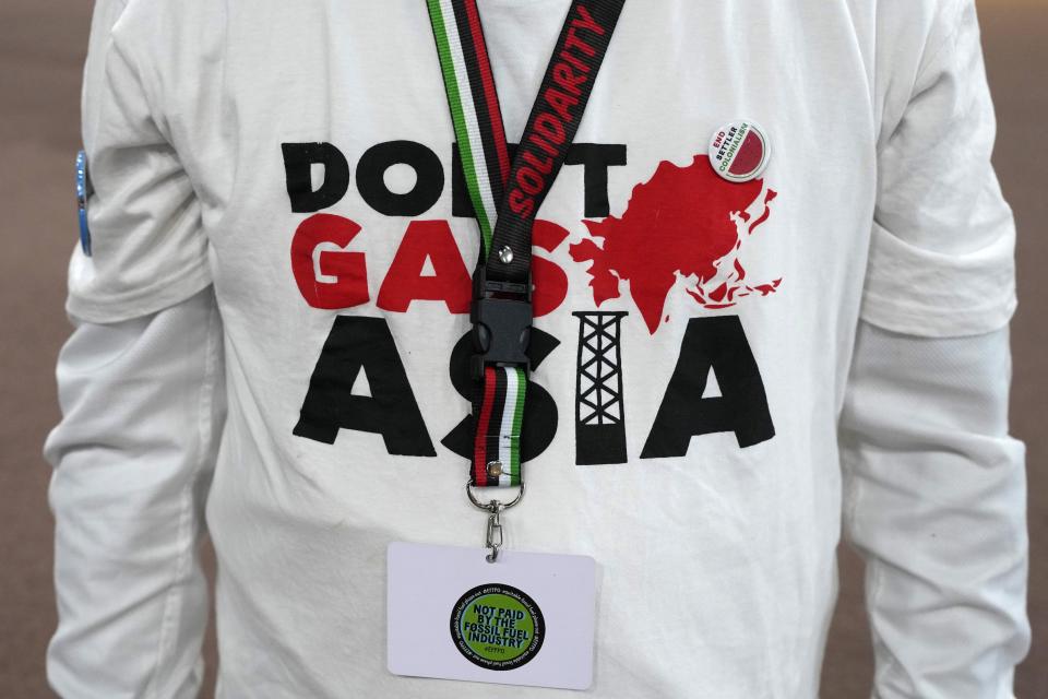 An activist wears a shirt that reads "don't gas Asia" at the COP28 U.N. Climate Summit, Tuesday, Dec. 5, 2023, in Dubai, United Arab Emirates. (AP Photo/Rafiq Maqbool)
