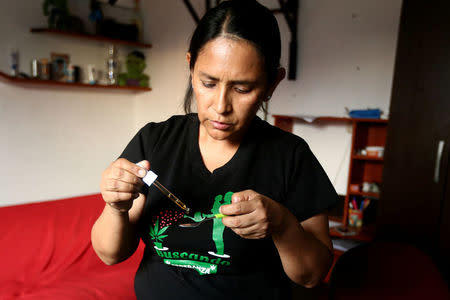 Ana Alvarez gives her son Anthony a spoonful of marijuana oil to soothe the symptoms of tuberous sclerosis and Lennox-Gastaut syndrome at her house in Lima, Peru, February 23, 2017. REUTERS/Guadalupe Pardo