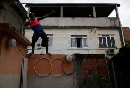 Felipe Roberto da Silva, 16, who trains in the Mangueira Olympic Village, poses outside his house in Vila Vintem slum in Rio de Janeiro, Brazil, August 16, 2016. REUTERS/Ricardo Moraes