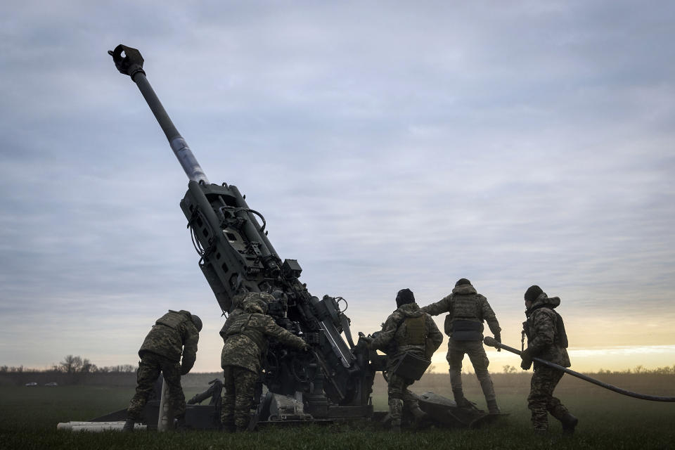 FILE - Ukrainian soldiers prepare a U.S.-supplied M777 howitzer to fire at Russian positions in Kherson region, Ukraine, Jan. 9, 2023. A rapidly expanding group of U.S. and allied troops and contractors are using phones and tablets to communicate in encrypted chat rooms to provide real-time maintenance advice to Ukrainian troops on the battlefield. As the U.S. and other allies provide a growing number of increasingly complex and high-tech weapons, the maintenance demands are expanding. (AP Photo/Libkos, File)