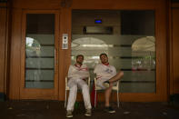 <p>Revelers dressed in white and red sleep, early in the morning at the end of the second day of the running of the bulls at the San Fermin Festival in Pamplona, northern Spain, July 8, 2018. (Photo: Alvaro Barrientos/AP) </p>