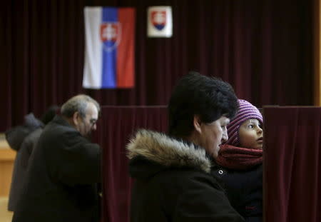 Voters prepare to cast their ballots at a polling station during the country's parliamentary election in the village of Ruzindol, Slovakia, March 5, 2016. REUTERS/David W Cerny