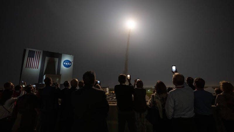 Guests watch the launch of NASA’s Space Launch System rocket carrying the Orion spacecraft on the Artemis I flight test, Wednesday, Nov. 16, 2022, from Operations and Support Building II at NASA’s Kennedy Space Center in Florida.