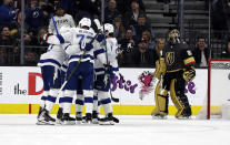 Tampa Bay Lightning players celebrate after forward Steven Stamkos, left, scored on Vegas Golden Knights goalie Marc-Andre Fleury (29) during the second period of an NHL hockey game Thursday, Feb. 20, 2020, in Las Vegas. (AP Photo/Isaac Brekken)