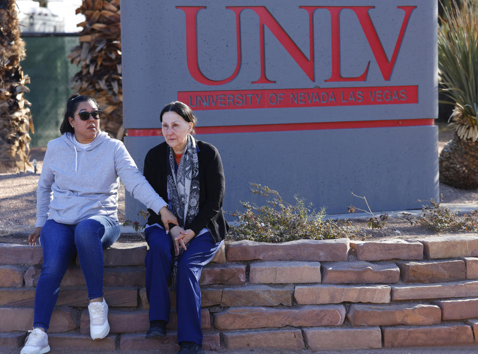 Two women sit after a shooting on the University of Nevada, Las Vegas, campus on Wednesday, Dec. 6, 2023, in Las Vegas. (Bizuayehu Tesfaye/Las Vegas Review-Journal via AP)