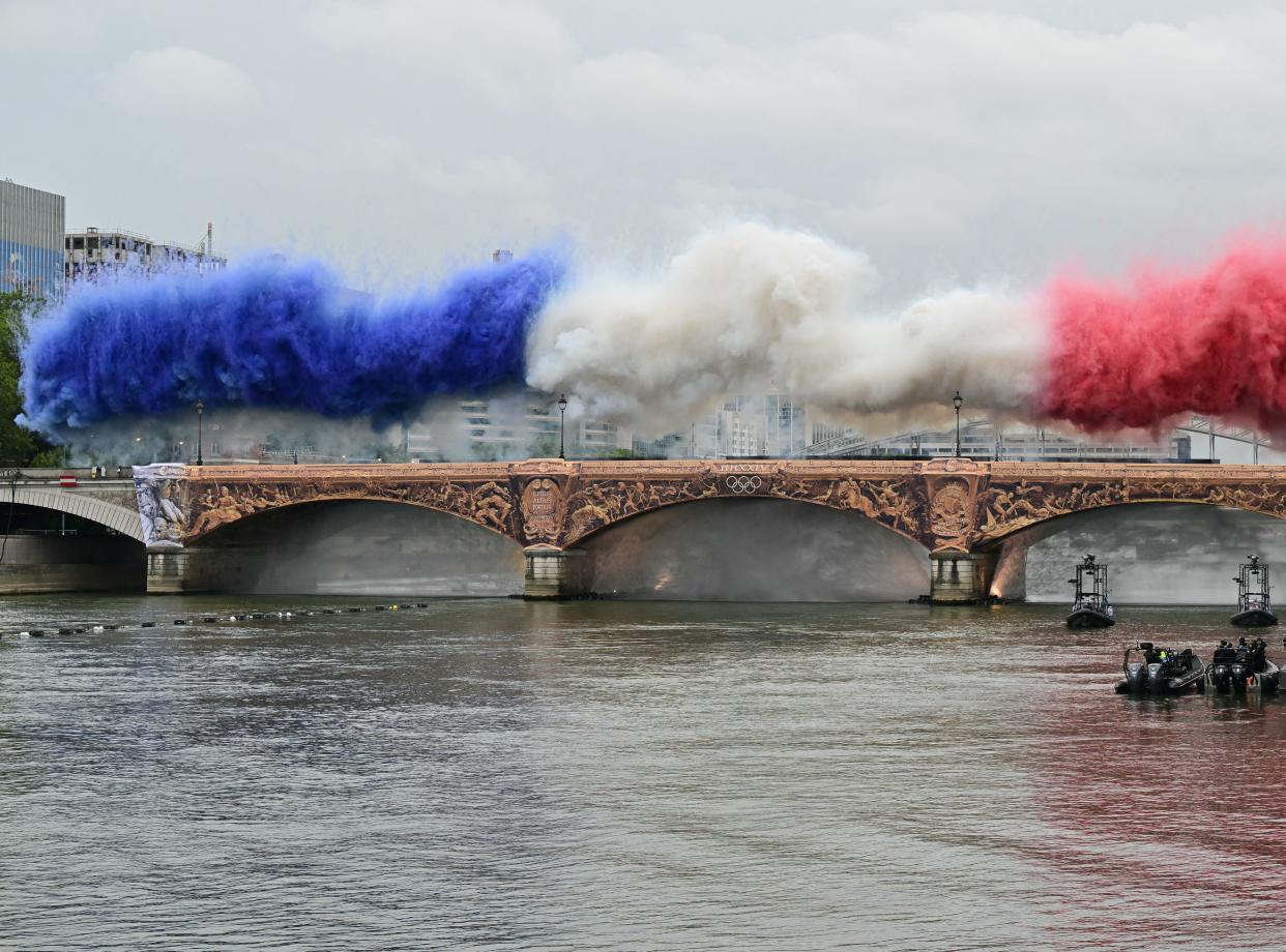 Fireworks in the French national colours explode over Pont d'Austerlitz during the opening ceremony of the Paris 2024 Olympics