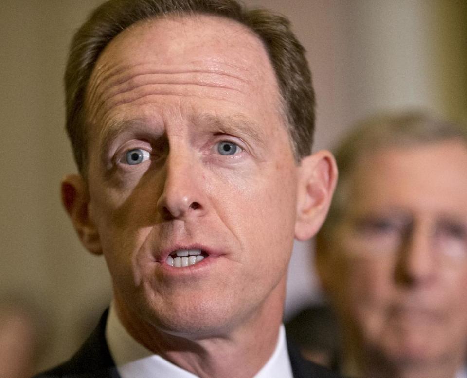 FILE - In this July 30, 2013 file photo, Sen. Pat Toomey, R-Pa. speaks with reporters on Capitol Hill in Washington. Flood insurance rate increases for hundreds of thousands of people would be put off under a bill that’s steaming toward passage in the Senate, powered by coastal lawmakers telling horror stories of constituents at risk of losing their homes with the implementation of an overhaul of the federal flood insurance program passed less than two years ago. The Senate measure to delay some of the changes is likely to pass after votes on a host of amendments, including a plan by Toomey to phase in rate increases more slowly. It was unclear whether the measure will pass on Wednesday or Thursday. (AP Photo/J. Scott Applewhite, File)