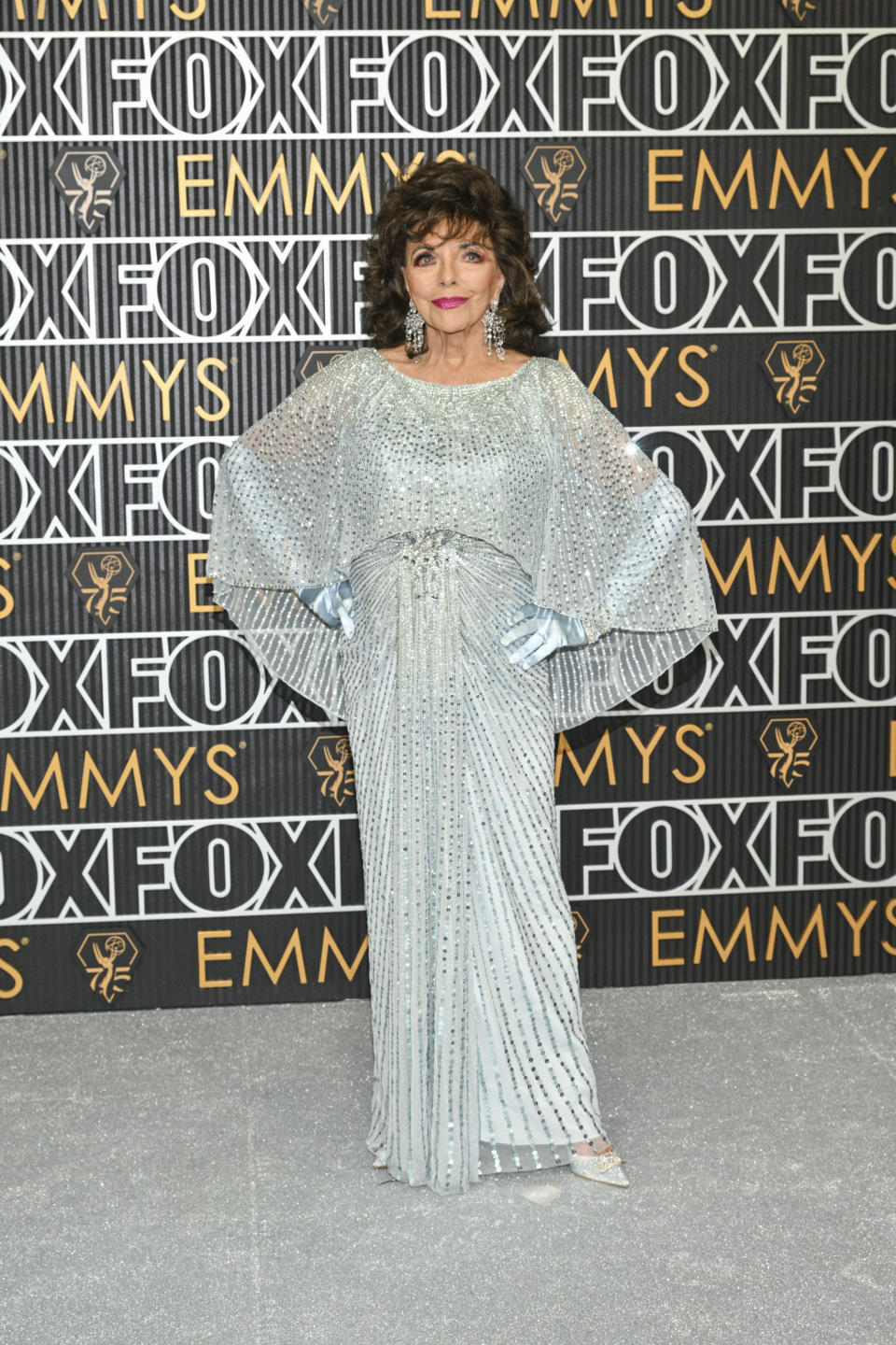 Joan Collins, sequin dress, red carpet, silver jewelry, Emmy Awards