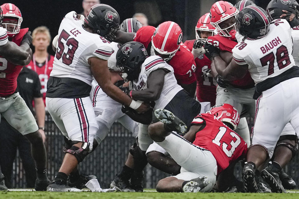 South Carolina running back Dakereon Joyner (5) scores a touchdown ona direct snap as Georgia's Nazir Stackhouse (78) and Mykel Williams (13) defend during the first half of an NCAA college football game Saturday, Sept. 16, 2023, Ga. (AP Photo/John Bazemore)