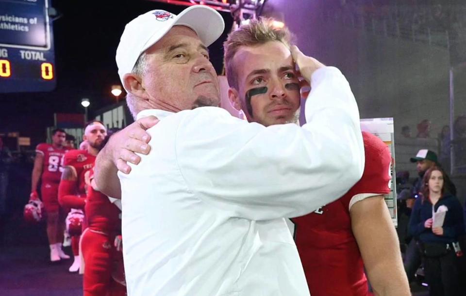 Fresno State coach Jeff Tedford embraces a tearful <span class="caas-xray-inline-tooltip"><span class="caas-xray-inline caas-xray-entity caas-xray-pill rapid-nonanchor-lt" data-entity-id="Jake_Haener" data-ylk="cid:Jake_Haener;pos:2;elmt:wiki;sec:pill-inline-entity;elm:pill-inline-text;itc:1;cat:Athlete;" tabindex="0" aria-haspopup="dialog"><a href="https://search.yahoo.com/search?p=Jake%20Haener" data-i13n="cid:Jake_Haener;pos:2;elmt:wiki;sec:pill-inline-entity;elm:pill-inline-text;itc:1;cat:Athlete;" tabindex="-1" data-ylk="slk:Jake Haener;cid:Jake_Haener;pos:2;elmt:wiki;sec:pill-inline-entity;elm:pill-inline-text;itc:1;cat:Athlete;" class="link ">Jake Haener</a></span></span> before the game against Wyoming on Friday, Nov. 25, 2022 at Valley Children’s Stadium. The record-setting quarterback was one of 13 Bulldogs honored on Senior Night before Fresno State shut out Wyoming 30-0. ERIC PAUL ZAMORA/ezamora@fresnobee.com