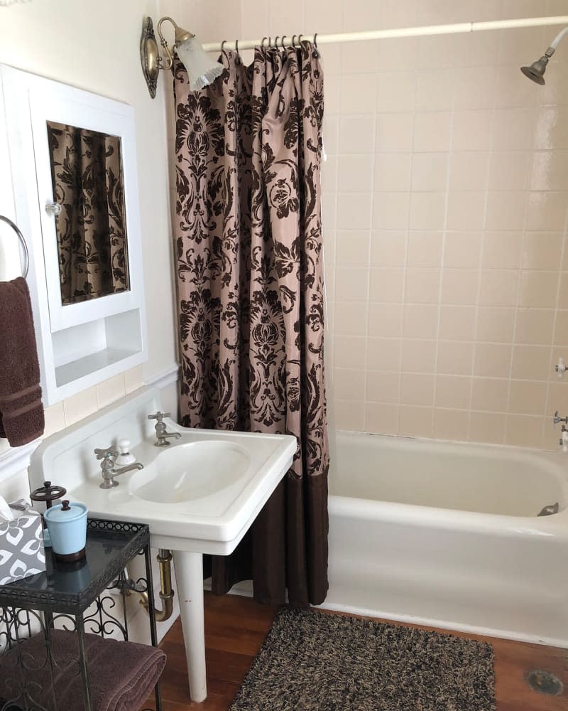 Pedestal sink in bathroom before renovation.