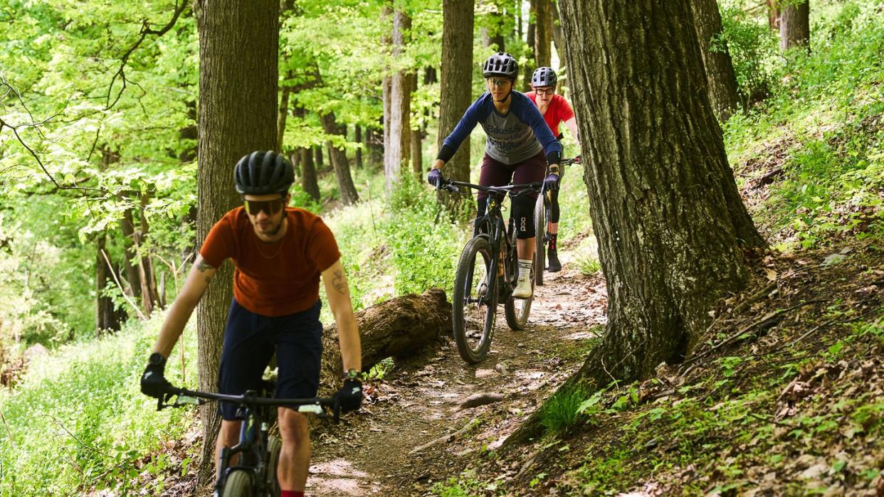 group of cyclists riding mountain bikes on a trail in trexlertown