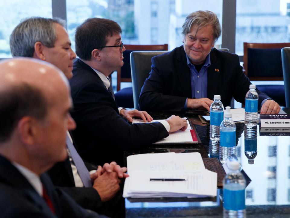 Steve Bannon, campaign CEO for Republican presidential candidate Donald Trump, right, looks on during a national security meeting with advisors at Trump Tower, Friday, Oct. 7, 2016, in New York.
