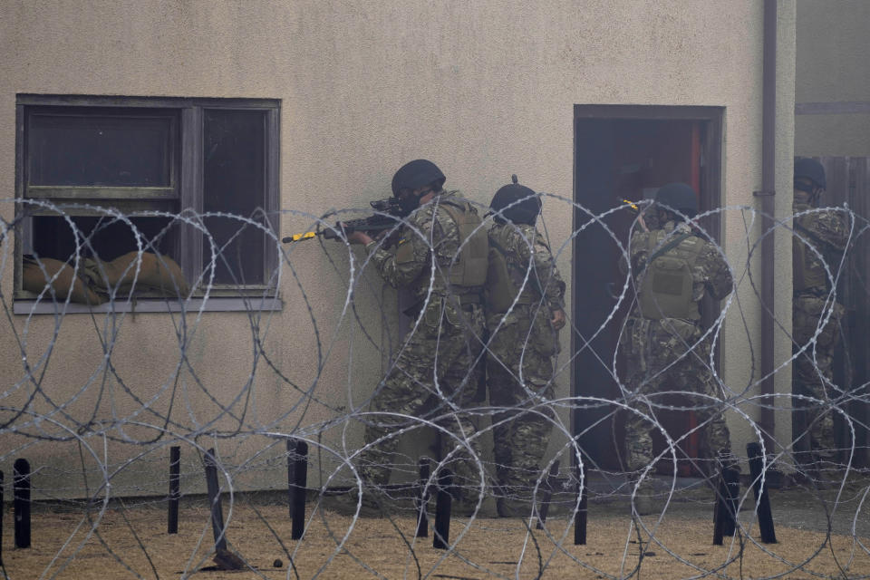 Ukrainian volunteer military recruits take part in an urban battle exercise whilst being trained by British Armed Forces at a military base in Southern England, Monday, Aug. 15, 2022. MOD and British Army as the UK Armed Forces continue to deliver international training of Ukrainian Armed Forces recruits in the United Kingdom.(AP Photo/Frank Augstein)