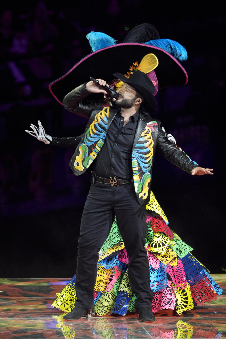 Mexican singer Leandro Aguilar, the son of Grammy-winning singer songwriter Pepe Aguilar, performs at the "Jaripeo Hasta Los Huesos Tour 2024" show at the Honda Center in Anaheim, Calif., on Friday, March 29, 2024. The show pays tribute to the Day of the Dead, a well-known Mexican celebration. (AP Photo/Damian Dovarganes)