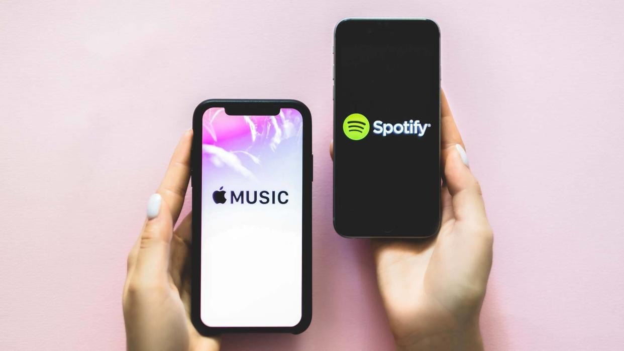  Apple Music logo and Spotify logo on phones  