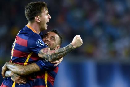 Barcelona defender Dani Alves (R) and forward Lionel Messi celebrate after scoring a goal. (AFP)