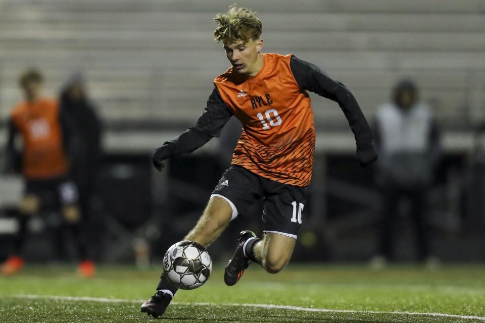 Ryle's Cole Marsh dribbles against Montgomery County Tuesday in the KHSAA Sweet 16 soccer tournament.