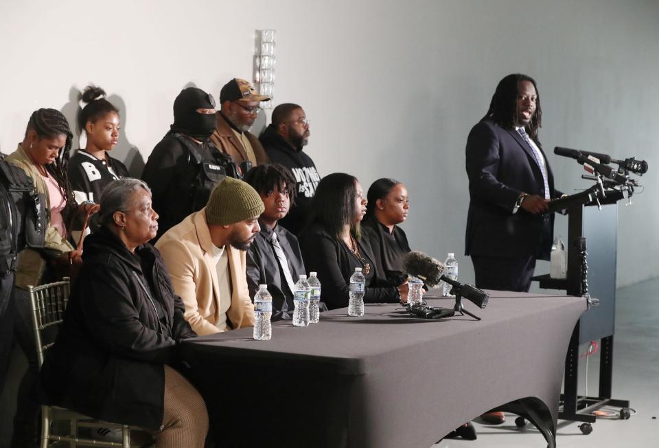 Tavion Koonce-Williams, the 15-year-old who was shot by an Akron police officer April 1, appears with his parents James Koonce and Angel Williams and other family members and supporters as they listen to his attorney, Imokhai Okolo address the media Friday during a press conference at 8 Point Hall in Akron.