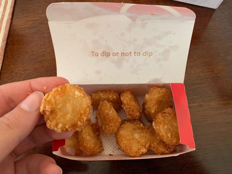 Chick-fil-a hash browns in their original red box on wooden table